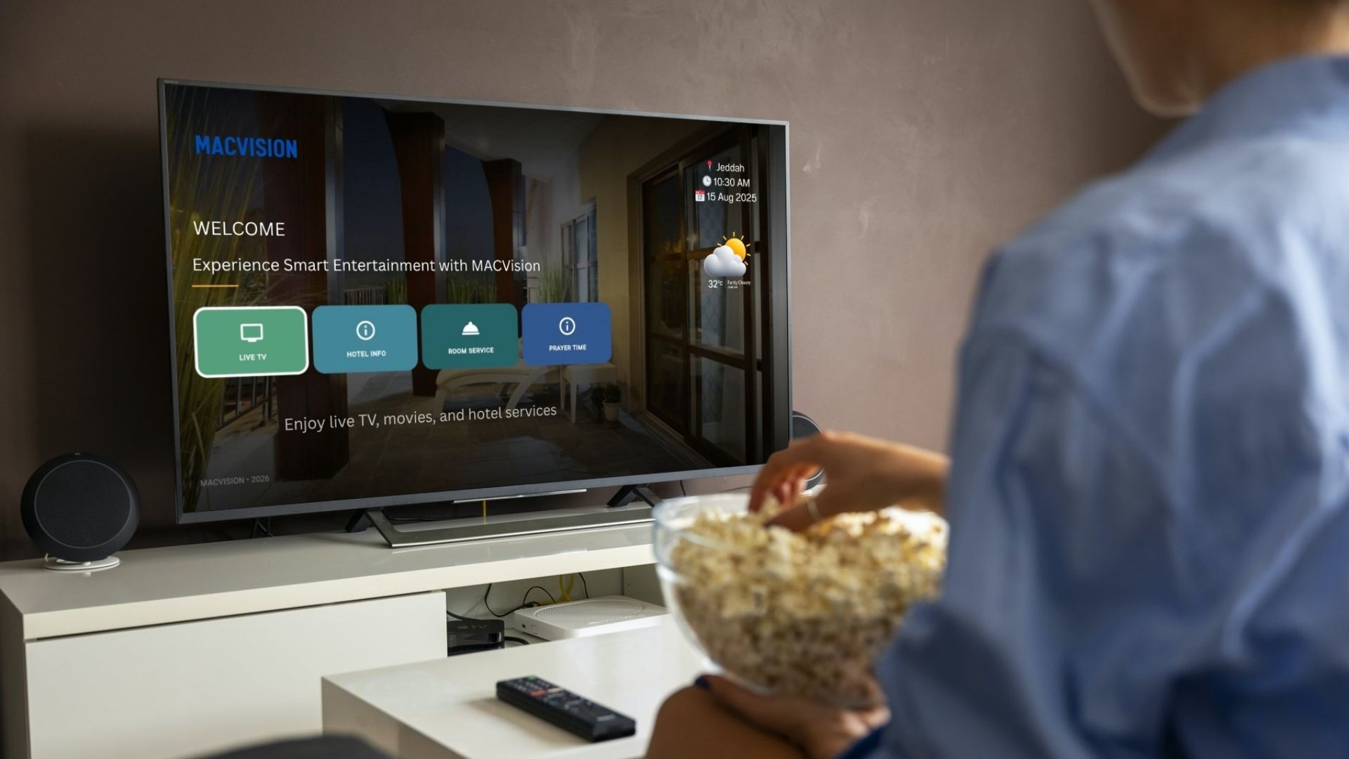 Guest watching MACVISION Smart TV in a hotel room